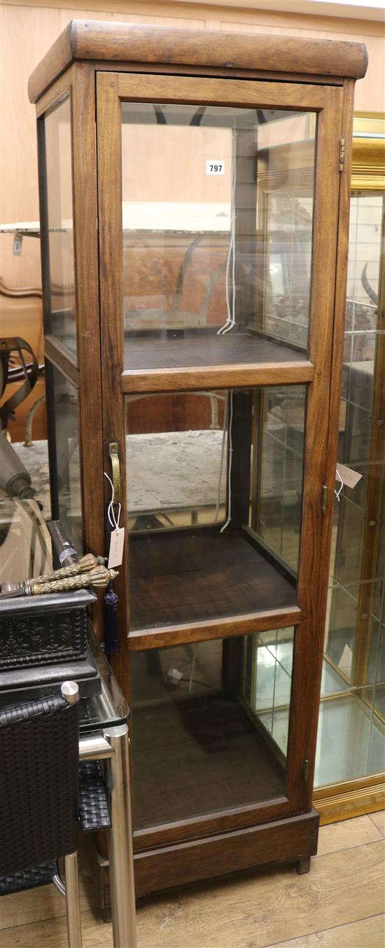 A four sided glazed square section display cabinet W.50cm